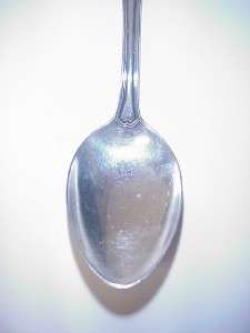 spoon is hallmarked with three cursive letters there are no handling 