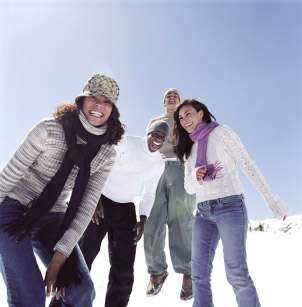 group of teen wearing clothing from a winter holiday gift basket