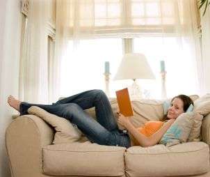 Woman on a couch, wearing stylish jeans
