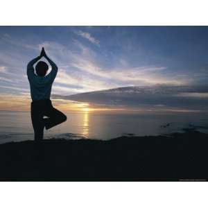  A Woman Practices Yoga on the Beach at Sunset National 
